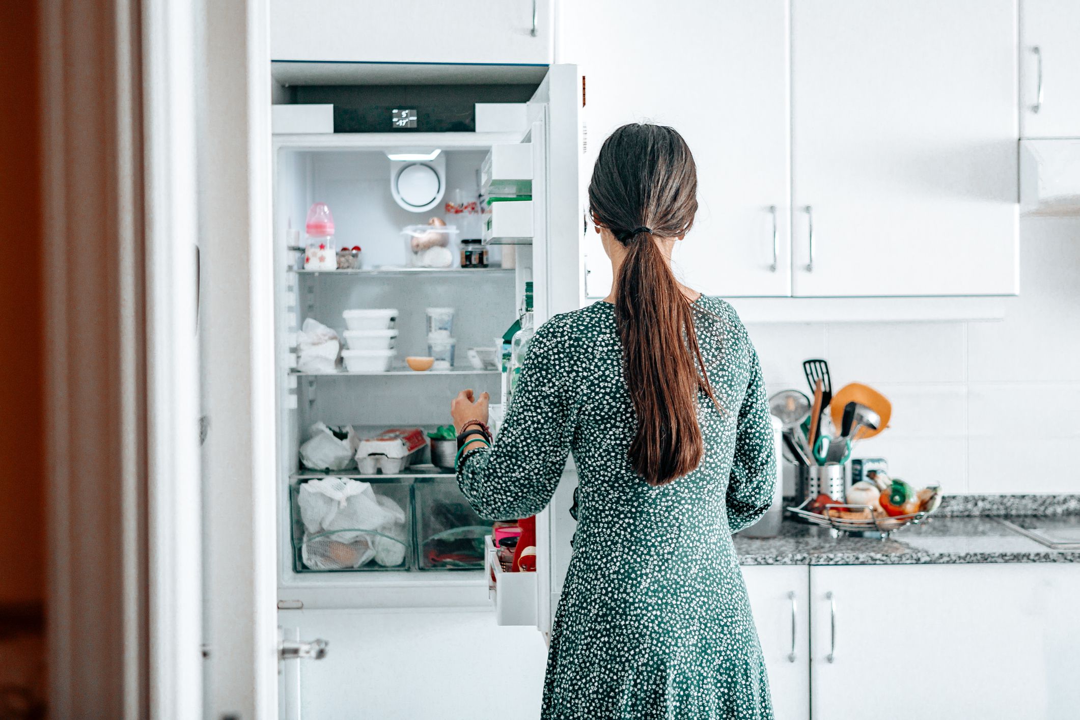 mulher em frente à geladeira