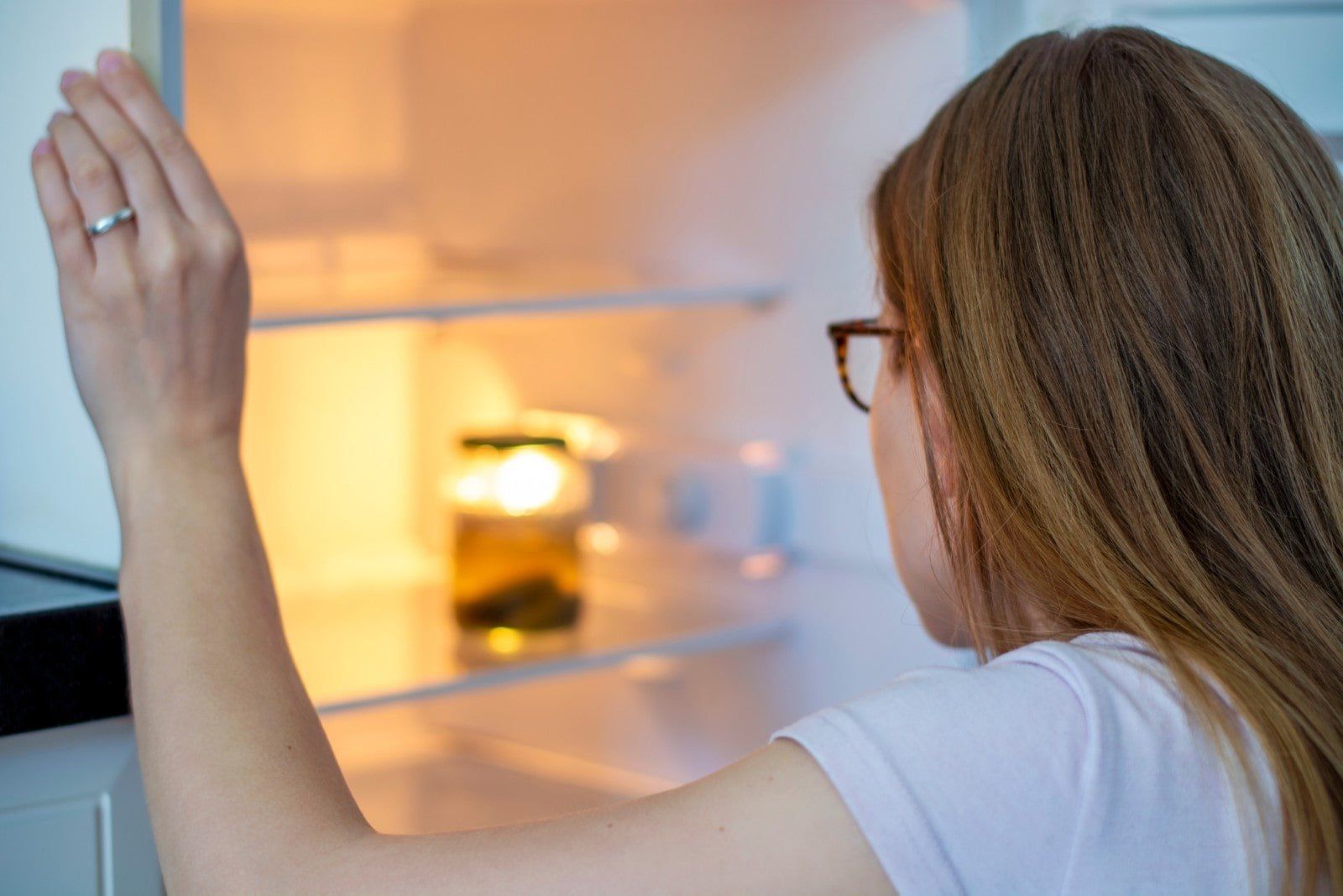 mulher olhando geladeira