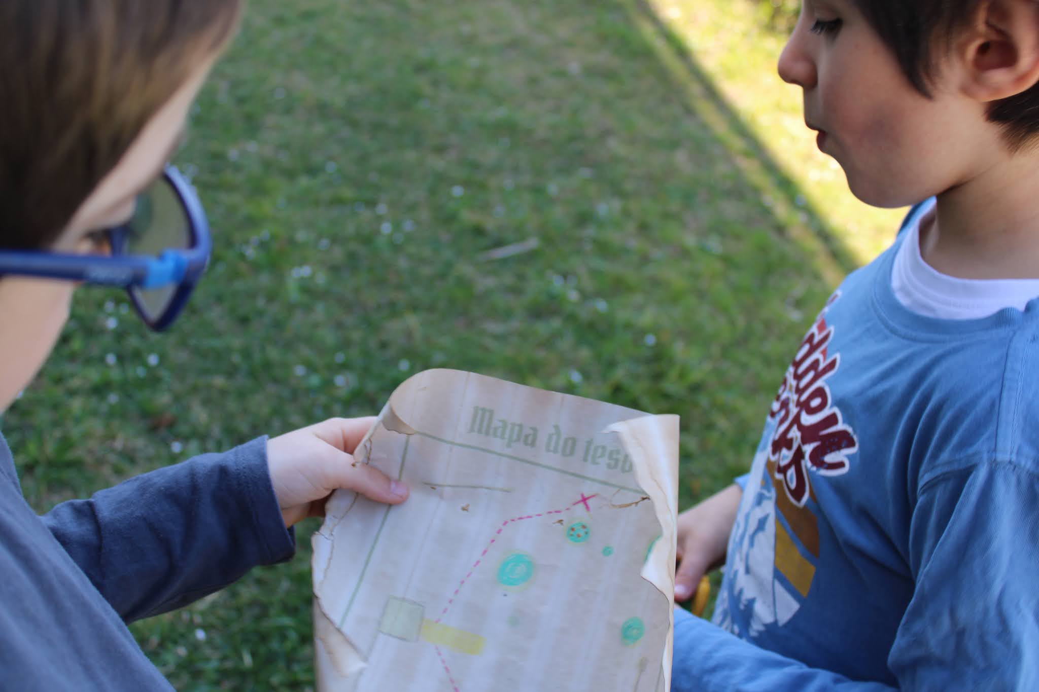crianças com mapa para caça de ovinhos de páscoa
