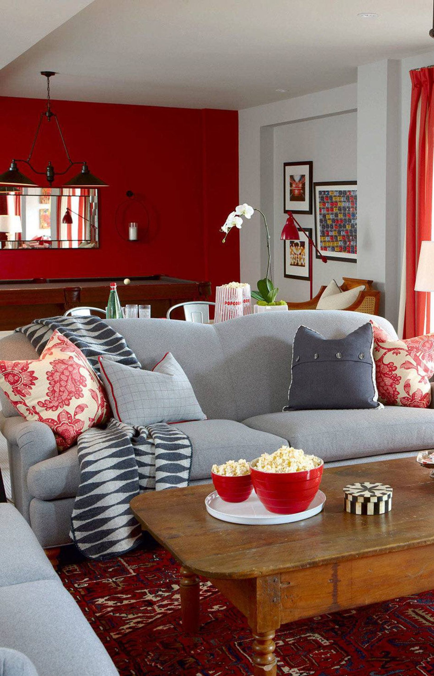 sala de estar com sofá cinza e detalhes vermelhos