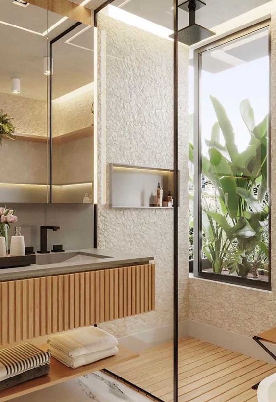 banheiro em pedra natural, madeira, deck e vegetaçao